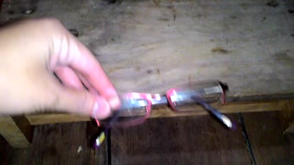 A single frame of a hand holding eyeglasses