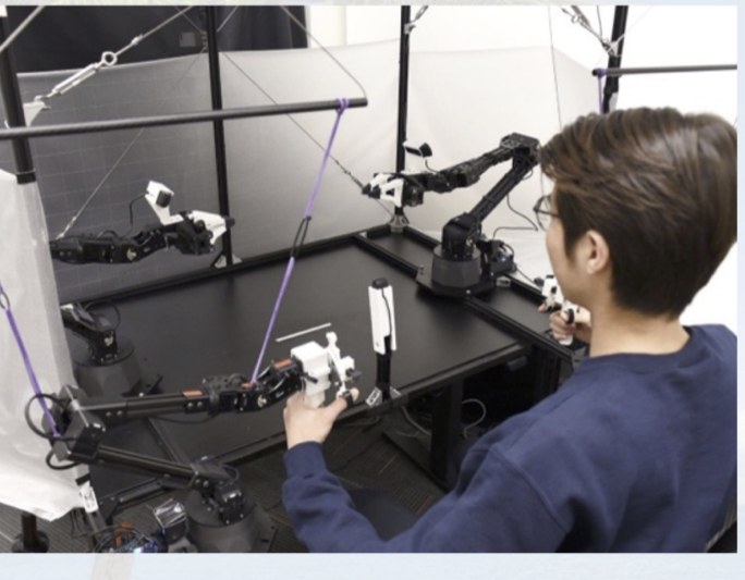A person teleoperating a real robot arm